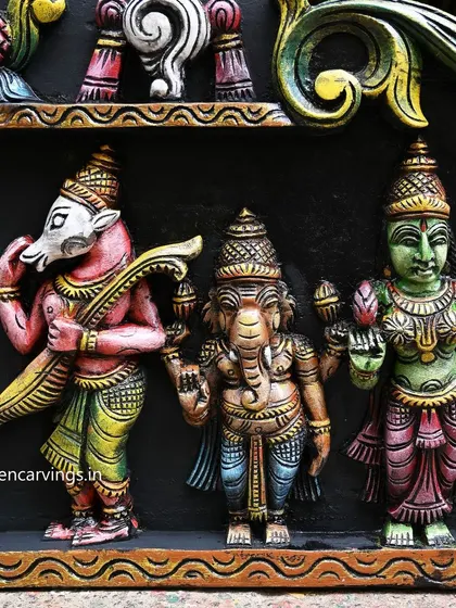 A close-up on the right side of the Meenakshi panel, featuring deities like Ganesha and Hayagriva, each carved and painted with unique details.