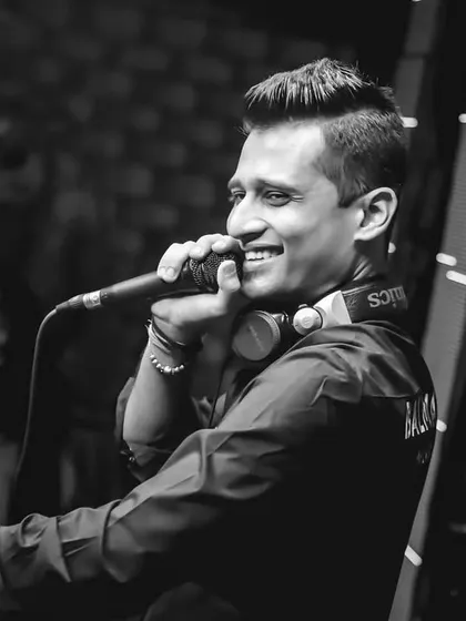 A black and white candid of me on the mic at Mobe Elante. A genuine smile is the best response to a crowd that's giving you all their energy.