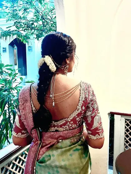 A beautiful back view of this bride's engagement blouse. The intricate embroidery and unique cut are designed to make a statement, even from behind.