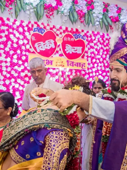 A ritual from the wedding ceremony, captured from a unique perspective that includes the family and the traditional decor.