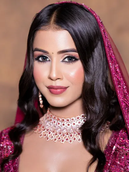 A close-up on a soft glam makeup look, perfectly accented by a delicate diamond and ruby choker set. This beautiful jewellery is available for rent to complete your party look.
