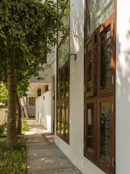 A view of the pathway along the side of the house. We ensured that the renovated structure allows for natural light and access around the entire building.