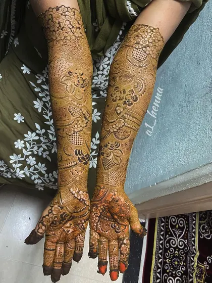 The full view of bride Daniya's henna, extending up to her elbows with personalized details hidden within the pattern.