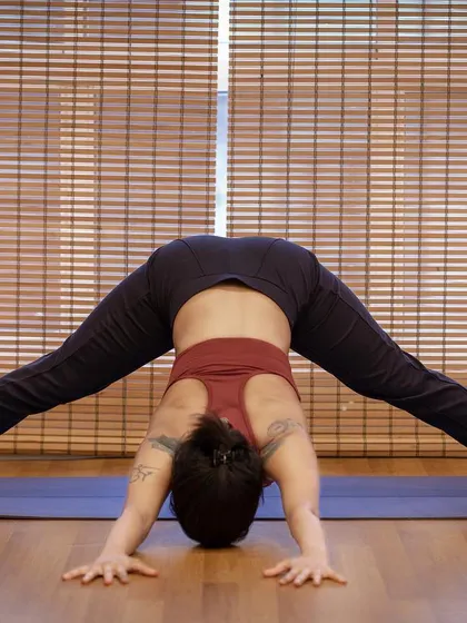 Prasarita Padottanasana, a wide-legged forward fold. This is an amazing stretch for the hamstrings and inner thighs, and it also helps to calm the mind as you fold inward.