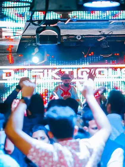 A view from the crowd, looking up at my illuminated name. The branding is strong, the energy is stronger.