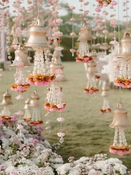 A close-up of the delicate floral bells and kalire hanging from the trees, adding a whimsical and traditional touch to the wedding decor.