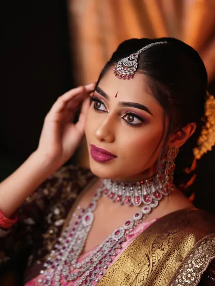 A thoughtful pose showing the detailed eye makeup and the intricate design of the diamond and ruby choker. The lighting catches the subtle shimmer on the skin.