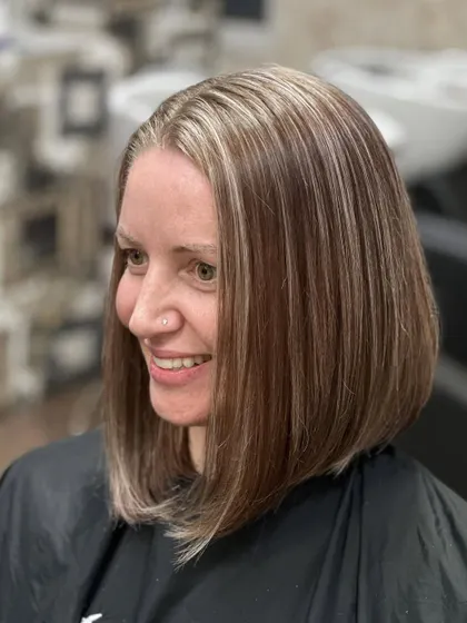 A smiling client after her color correction. We removed the old box dye and gave her a fresh, modern ash-blonde look.