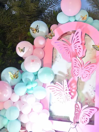 A detailed shot of the butterfly panel and balloon decor, showing the small gold butterfly stickers that add a touch of sparkle.