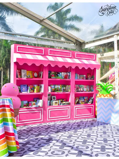 As a unique party favour idea, I created this bright pink book stall. It was designed to look like a sweet shop, allowing each child to pick a book to take home.