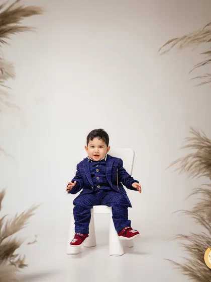 Looking sharp for his first birthday! We also offer more formal portrait options, like this shot of a little gentleman in a plaid suit, framed by elegant pampas grass.