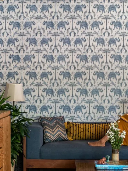 A quiet moment in the Boho-Desi lounge, perfect for reading. The vibrant wallpaper and comfortable sofa create an inspiring and relaxing corner, showcasing how our designs support everyday moments of peace.