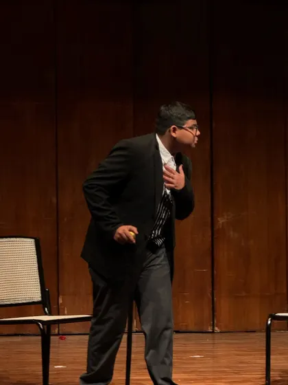 An actor delivers a dramatic monologue, using posture and expression to build his character.