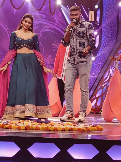 On stage with the talented actress Sapthami Gowda during the 'Ugadi Utsava' show on Star Suvarna, explaining a dance move.