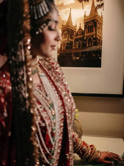 An artistic, soft-focus shot of the bride. This portrait emphasizes the rich colors and textures of her Nikaah attire, creating a dreamy and romantic mood.