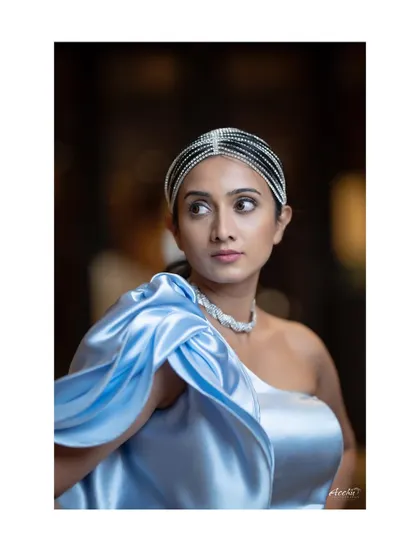 A close-up on the details. This image focuses on the unique headpiece and the texture of the dress, offering a different perspective from the same high-fashion event shoot.