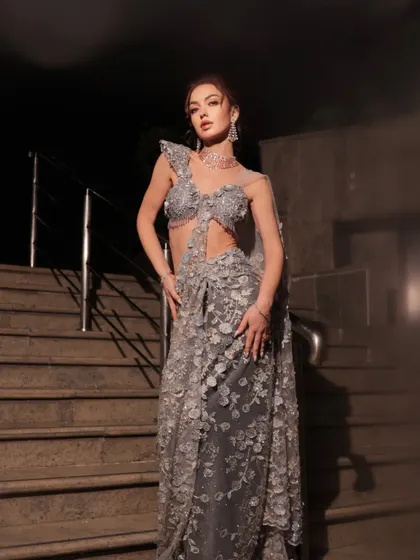 A full-length shot of the silver-grey saree-gown, its texture and drape are simply exquisite.