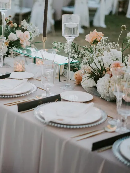 A beautifully arranged table ready for a bespoke sit-down meal. Our culinary team designs multi-course menus that take guests on a journey through different flavors and cuisines, all presented with an elevated touch.