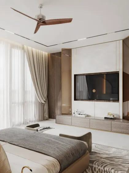 In this bedroom, we designed a full-wall media unit using white marble and wood veneer panels, framed by metal screens. The result is a clean, integrated look that combines storage and display with high-end finishes.
