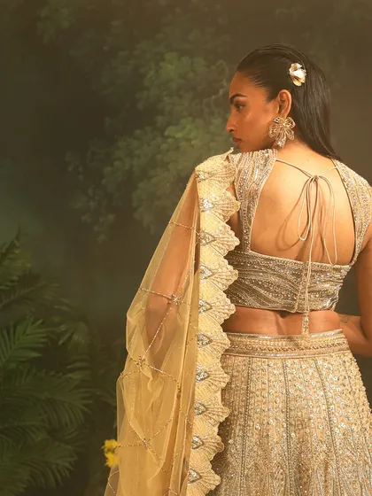 The back of the Jade Lehenga, showing the intricate blouse design and the beautiful drape of the scalloped dupatta. A modern take on a bridal classic.