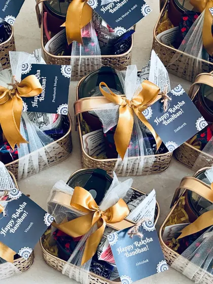 An assortment of our Rakhi hampers ready for delivery, each one packed with care and beautifully presented in a golden metal basket.