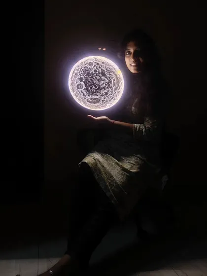 Another view of the illuminated 3D moon art, showcasing its spherical illusion and detailed texture. It's a conversation starter and a unique piece of functional art.