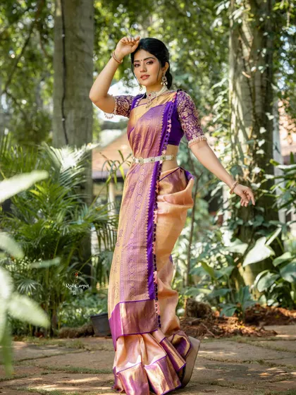 The rich purple and gold of this Kanjivaram saree create a look of pure royalty. Megha Shetty carries it with such grace and elegance.