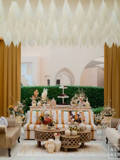 An intimate seating area from our 'Markets of the Middle East' event. The striped sofa, textured coffee tables, and paper installation on the ceiling created a cozy and stylish corner for guests.