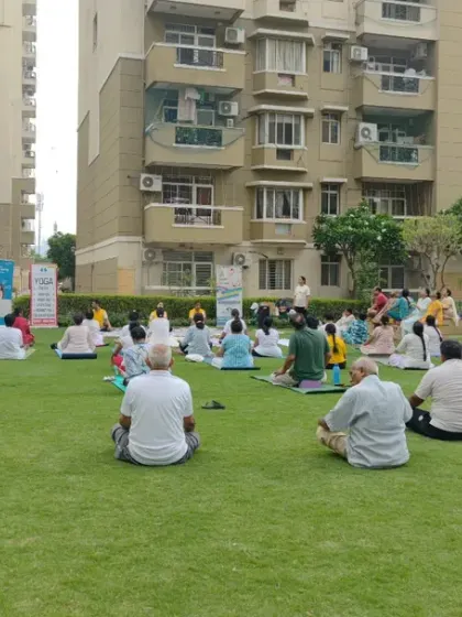 Another view of our large outdoor yoga class, showing people of all ages and backgrounds practicing together. Yoga is truly for everyone.