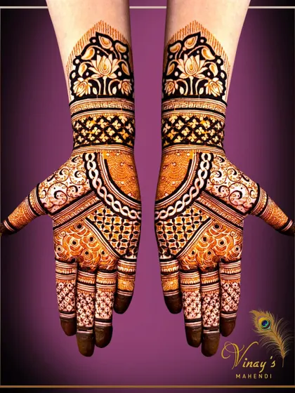 A bold and modern design with geometric patterns and a lotus cuff. The contrast between the dark and light henna is stunning.