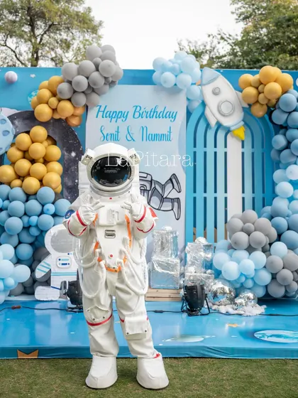 The astronaut mascot making an appearance, ready to interact with the birthday boys and their friends.