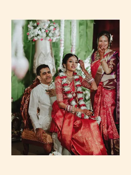 A heartwarming photo of the bride with her parents during the wedding ceremony.