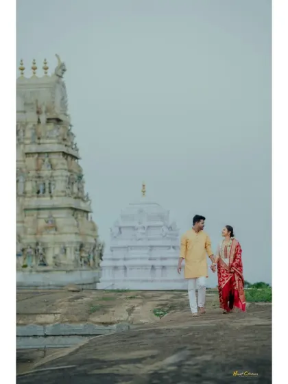 A full-length portrait of a couple during their pre-wedding shoot, set against the majestic backdrop of a temple.