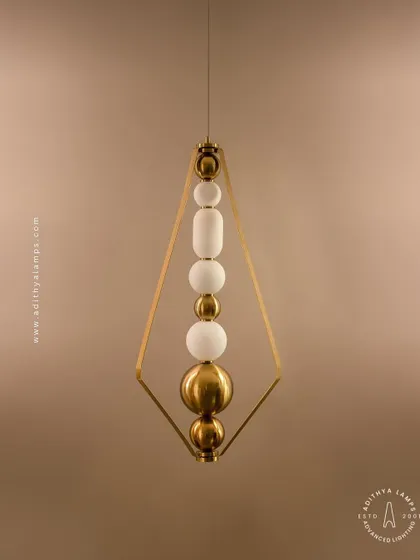 This elegant pendant is framed by a triangular gold structure, enclosing a string of white and gold beads. It's a sophisticated and modern piece that adds a touch of jewelry-like decoration to your space.