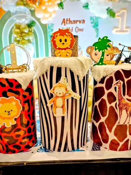 Themed cake stands are a great way to enhance the party's look. For this safari party, we used plinths decorated with zebra, giraffe, and leopard print's, topped with cute animal figure's.