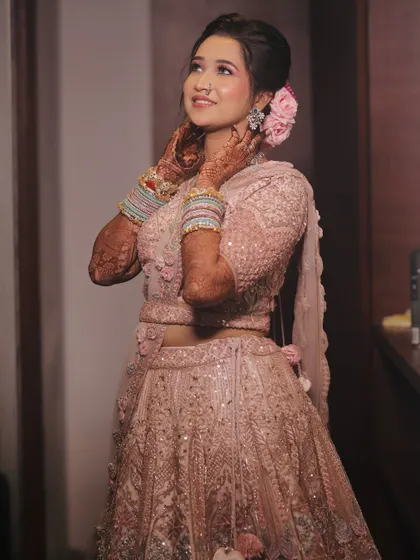 A lovely pose showing the floral hair accessories and the intricate details of her lehenga.