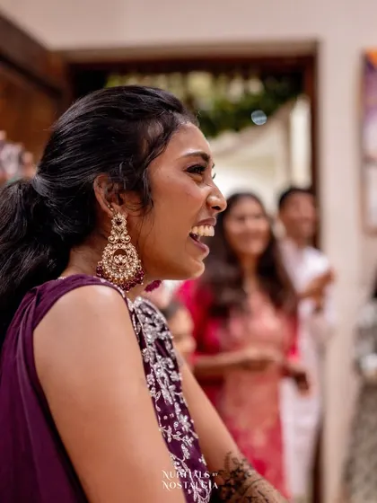 The bride's joyous reaction to a surprise performance by her friends and family.