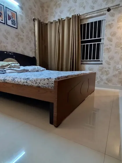 Another angle of the bedroom with the beige monstera leaf wallpaper, showing how it creates a cohesive and warm atmosphere throughout the room.