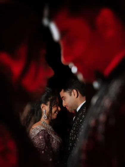 A creative portrait of a couple, framed by a reflection. This artistic approach adds a layer of depth and intrigue to their engagement photo.