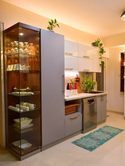 This angle showcases the glass crockery unit and the integrated dishwasher. It’s all about seamless design and functionality.