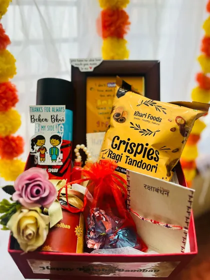 This personalized Rakhi hamper is perfect for a brother, filled with his favorite snacks and a custom photo frame.