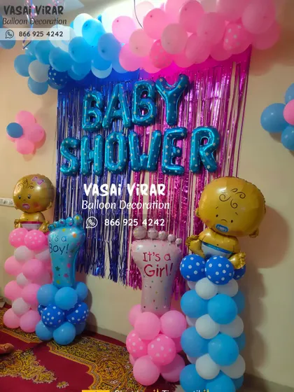 This is a fun and simple baby shower decoration perfect for home celebrations. It includes a shimmering foil curtain, "BABY SHOWER" foil letters, and balloon pillars topped with baby-shaped and foot-shaped foil balloons.