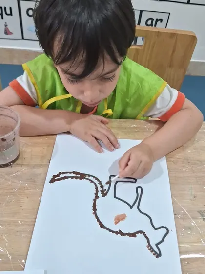 Another child uses brown paint to create his kangaroo art. I provide different colors so each child can make the project their own.