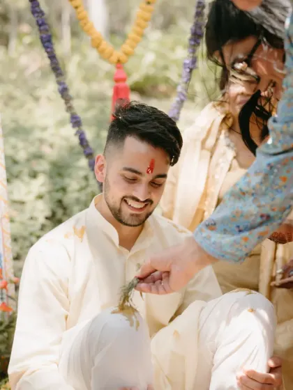 The groom receiving blessings during his Haldi ritual. We ensure all traditions are honored beautifully, surrounded by family and love.