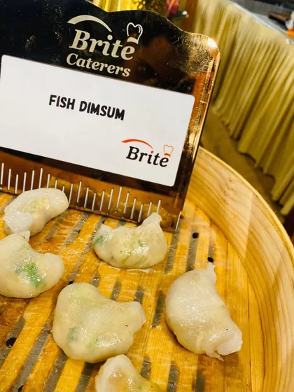 A close-up of delicate Fish Dim Sum, steamed to perfection in a bamboo basket.