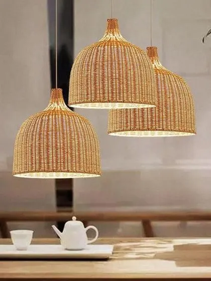 This set of three classic dome-shaped pendant lights, woven from natural rattan, provides a warm, downward glow perfect for suspension over a dining table or kitchen island. Their timeless design complements a wide range of interior styles.