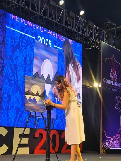 Here I am on stage, guiding a workshop for 200 people. It's a long way from my first event, and I love the challenge and excitement of leading such large, creative sessions.