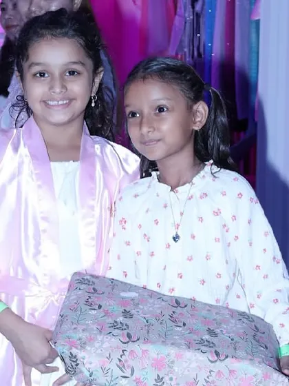 Two friends in their spa robes, ready to enjoy the party and open presents.