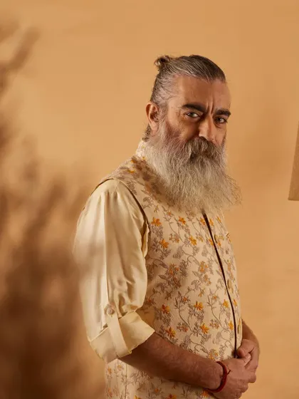 This floral printed vest in neutral tones offers a sophisticated yet relaxed look. It's a versatile piece that can be dressed up or down for any semi-formal occasion.