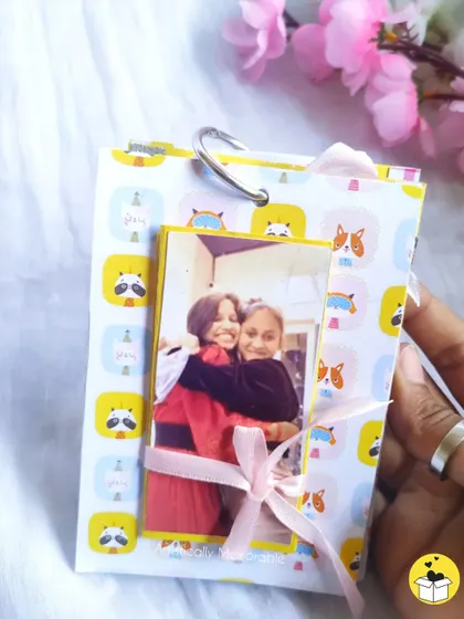 A mini tag book with a cute animal-print cover, held open to show a photo inside. Perfect for a friend.